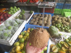 Enjoying a fresh coconut at the fruit and vegetable stand.